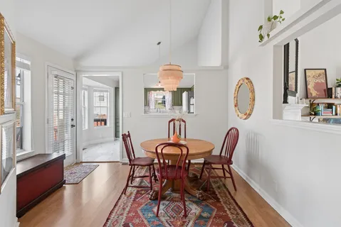 a view of a dining room with furniture and chandelier