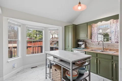 a kitchen that has a table and a sink in it
