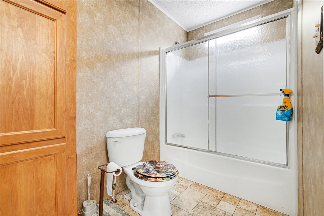 1004 Chapman Road Honea Path, SC 29654 - Photo 15 of 30 This bathroom features a shower with sliding doors and ample space for daily routines.