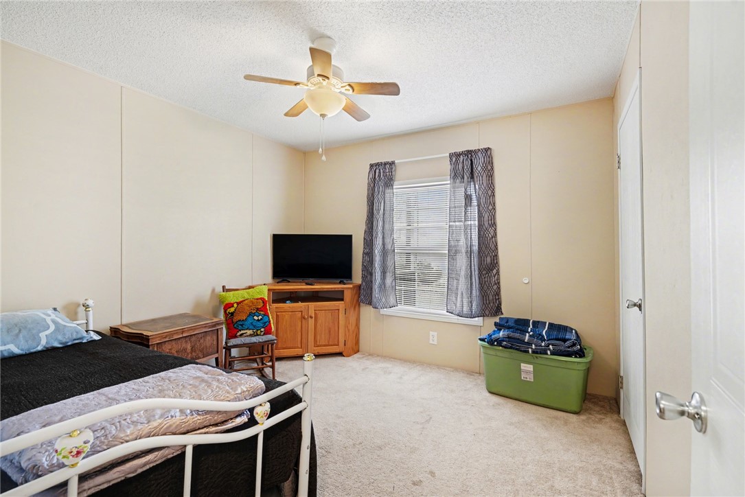 1004 Chapman Road Honea Path, SC 29654 - Photo 16 of 30 This cozy bedroom features comfortable carpeting and a ceiling fan, perfect for relaxation.