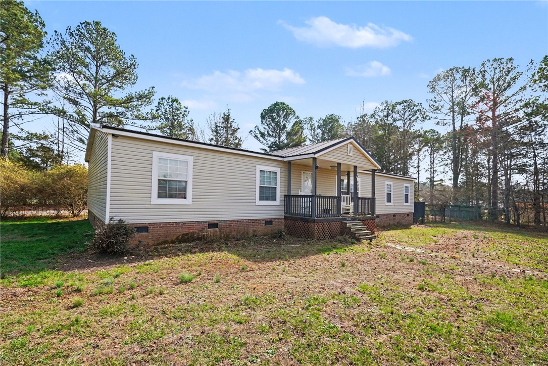 1004 Chapman Road Honea Path, SC 29654 - Photo 2 of 30 This charming residence features a welcoming porch, nestled amidst mature trees, offering a serene outdoor setting.