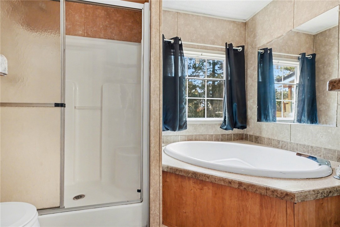 1004 Chapman Road Honea Path, SC 29654 - Photo 21 of 30 This serene bathroom offers both a shower and a soaking tub for ultimate relaxation.