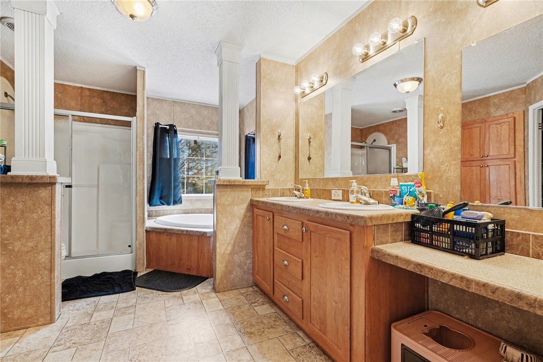 1004 Chapman Road Honea Path, SC 29654 - Photo 23 of 30 This functional bathroom features a dual vanity, separate shower, and a relaxing soaking tub.