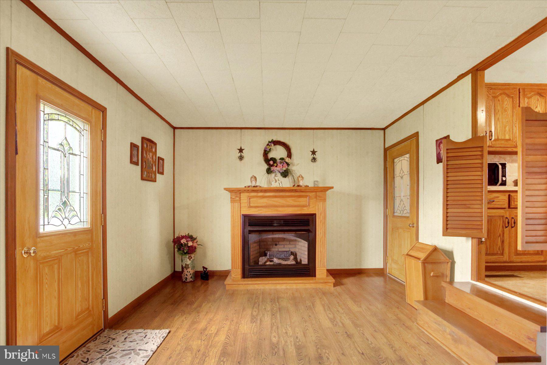 72 Cedar Grove Road Mifflintown, PA 17059 - Photo 14 of 31 a view of an empty room with a fireplace and a window