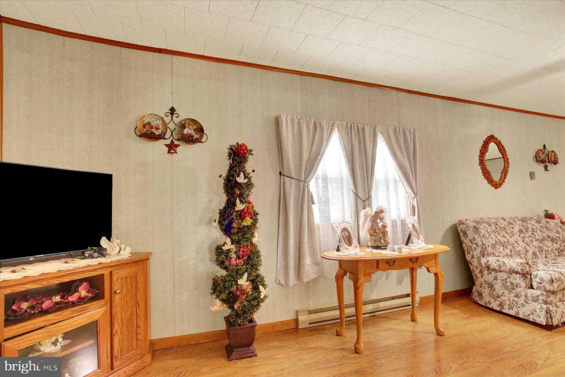 72 Cedar Grove Road Mifflintown, PA 17059 - Photo 15 of 31 a living room with furniture and a flat screen tv