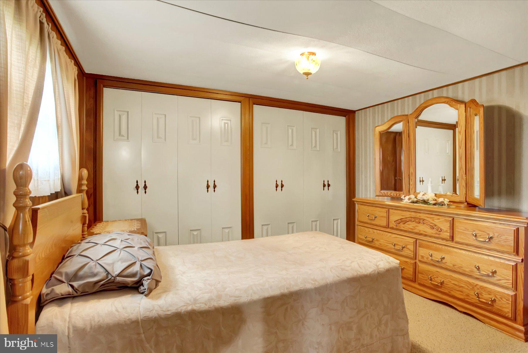 72 Cedar Grove Road Mifflintown, PA 17059 - Photo 18 of 31 a bedroom with a large bed and large windows