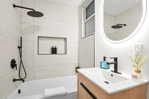 a bathroom with a sink a mirror and a shower