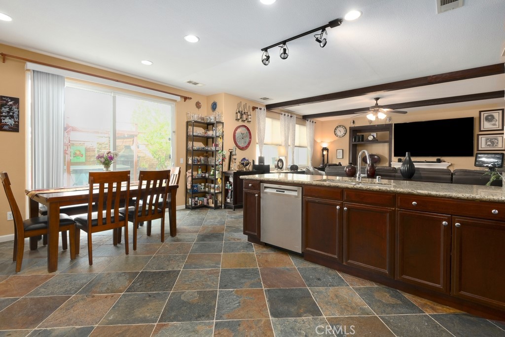 130 Daylily Drive Perris, CA 92571 - Photo 12 of 43 a large kitchen with a dining table chairs and large window