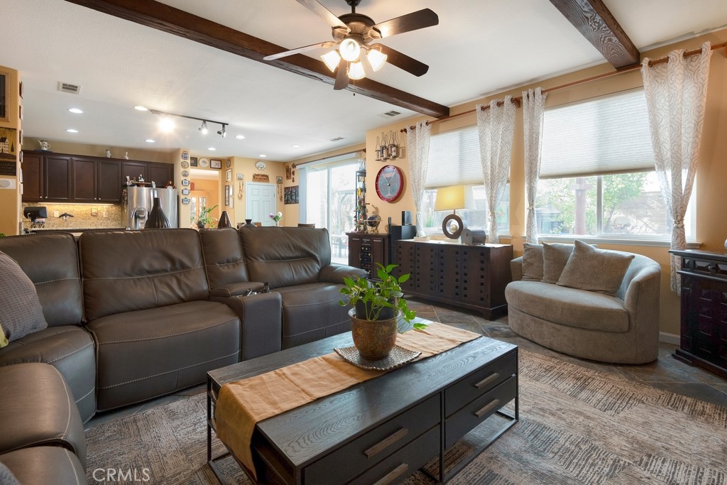130 Daylily Drive Perris, CA 92571 - Photo 16 of 43 a living room with furniture ceiling fan and a window