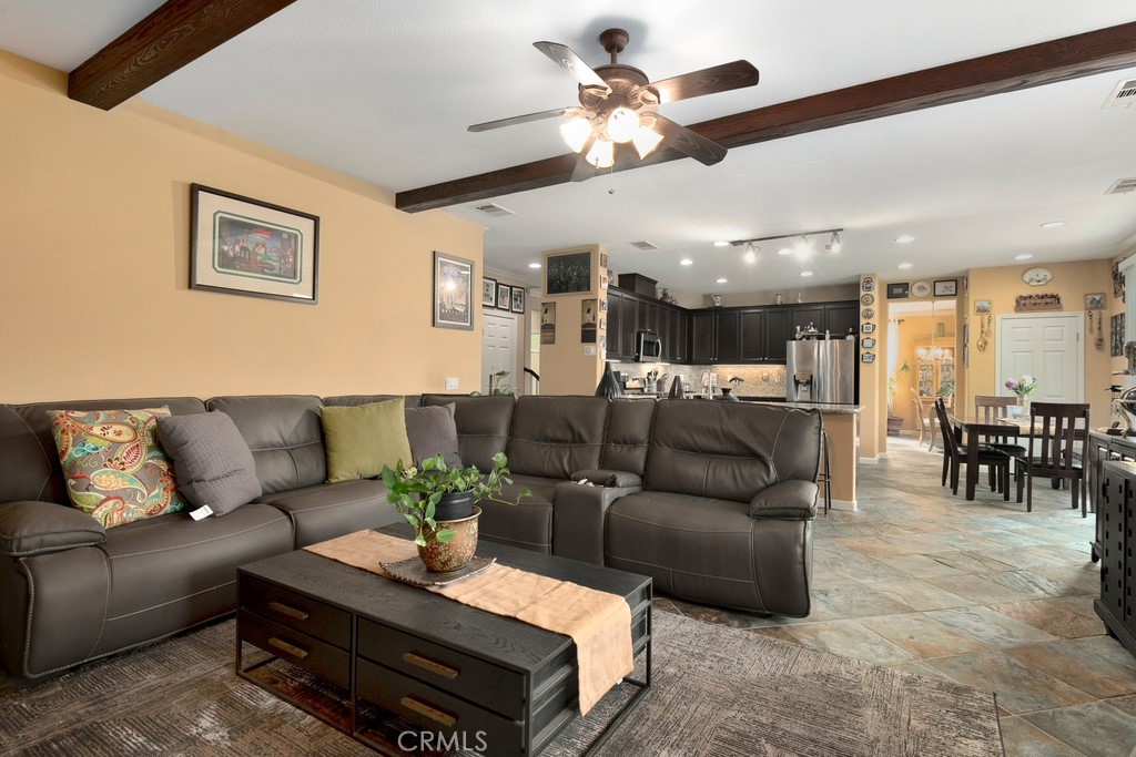 130 Daylily Drive Perris, CA 92571 - Photo 17 of 43 a living room with furniture and a dining table