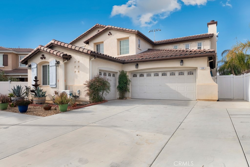 130 Daylily Drive Perris, CA 92571 - Photo 2 of 43 a front view of a house with garden