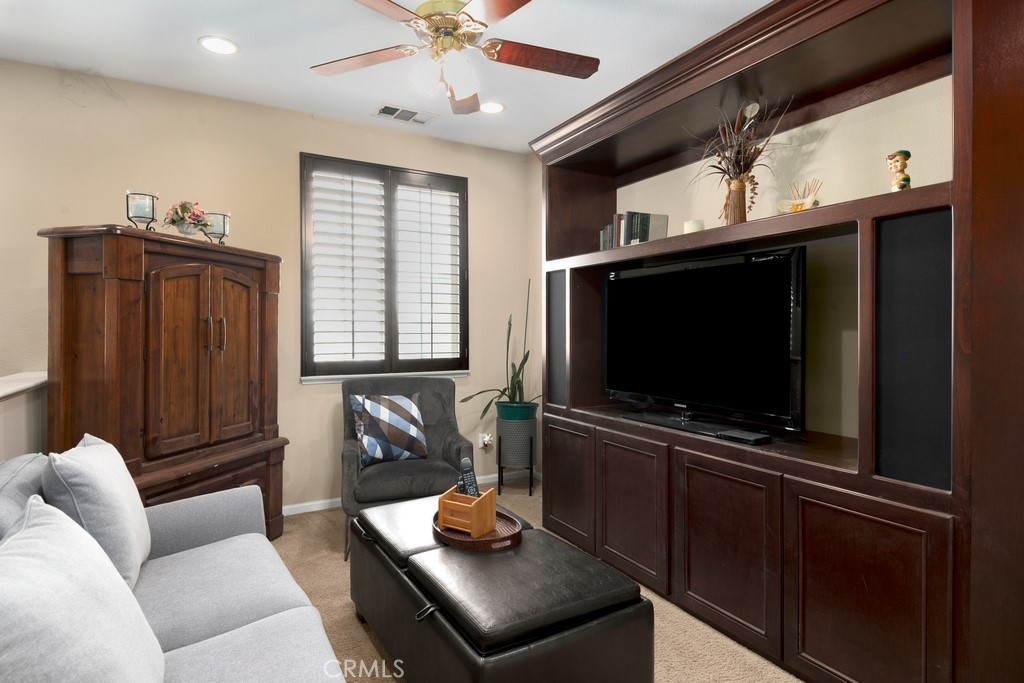 130 Daylily Drive Perris, CA 92571 - Photo 21 of 43 a living room with furniture and a flat screen tv