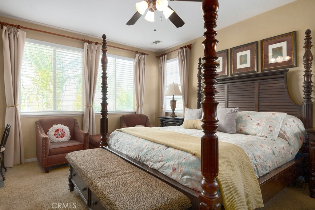 130 Daylily Drive Perris, CA 92571 - Photo 23 of 43 a bedroom with a bed and a chandelier