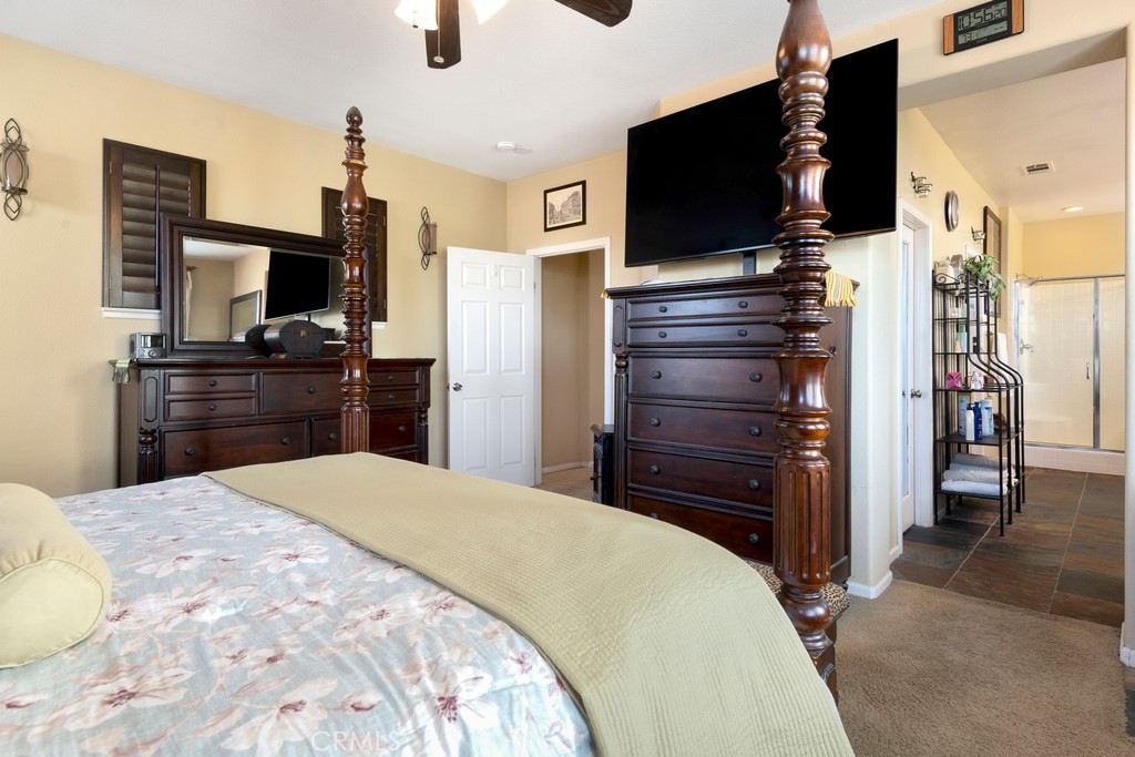 130 Daylily Drive Perris, CA 92571 - Photo 25 of 43 a bedroom with a bed and a flat screen tv