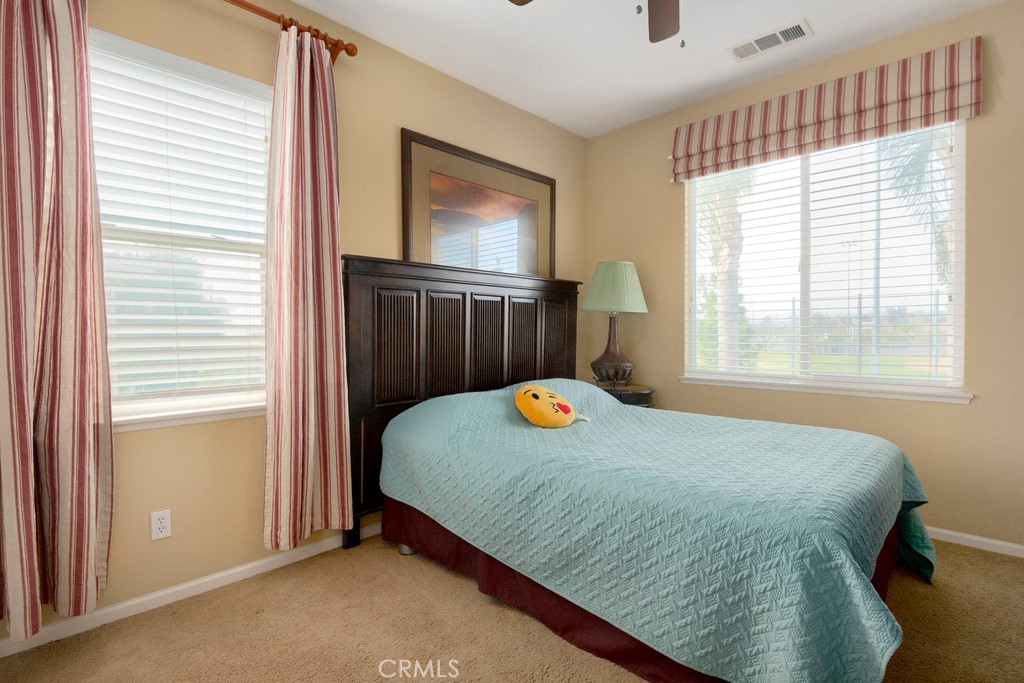 130 Daylily Drive Perris, CA 92571 - Photo 27 of 43 a bedroom with a bed and a window