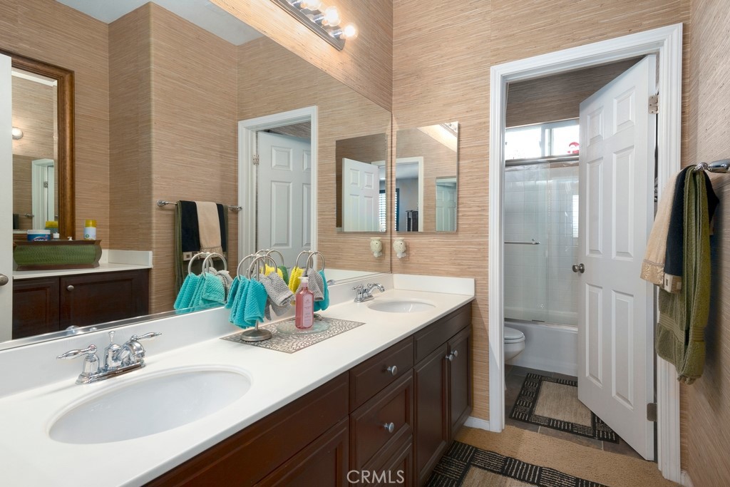 130 Daylily Drive Perris, CA 92571 - Photo 29 of 43 a bathroom with a double vanity sink and mirror