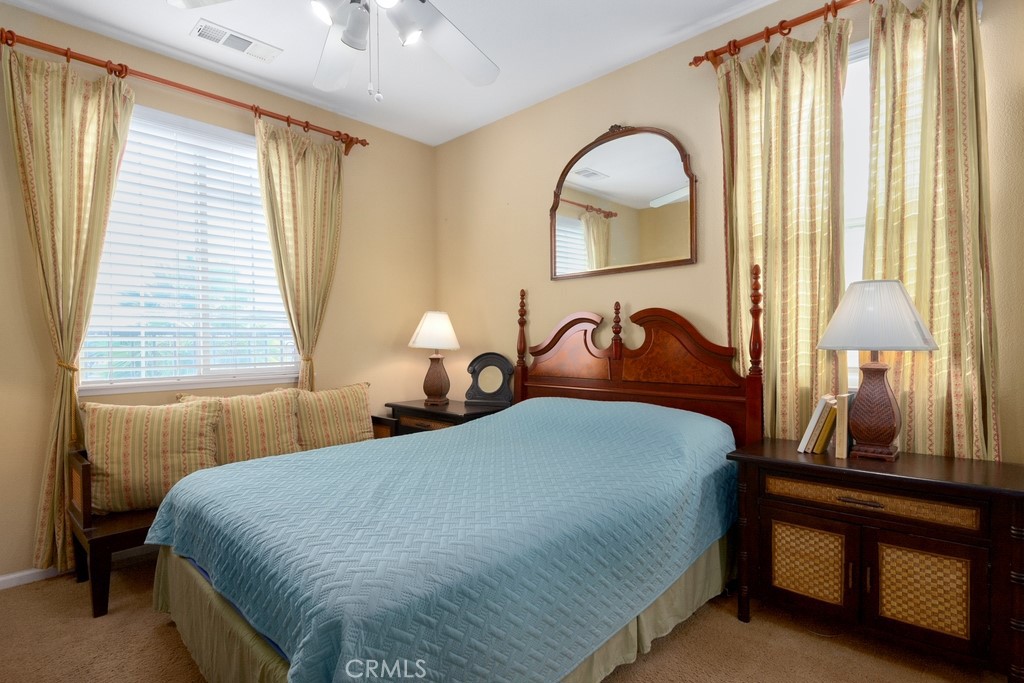 130 Daylily Drive Perris, CA 92571 - Photo 30 of 43 a bedroom with a bed and a painting on the wall