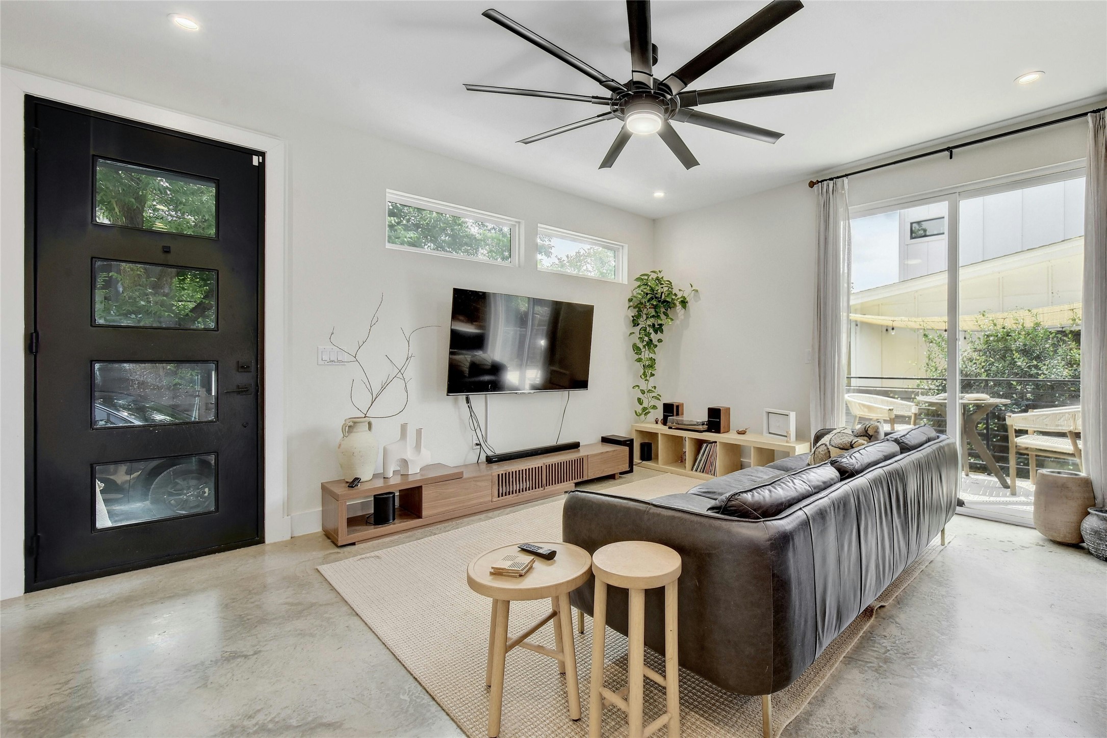 4606 Ledesma Road, Unit 2 Austin, TX 78721 - Photo 6 of 33 Enter into a bright living room featuring high ceilings and direct access to an outdoor patio.