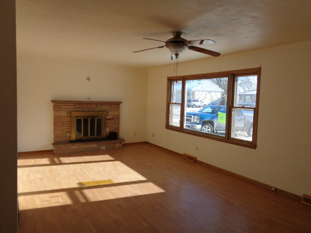 413 Phyllis Avenue Rochelle, IL 61068 - Photo 2 of 17 a view of an empty room with a fireplace and a window