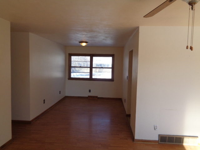 413 Phyllis Avenue Rochelle, IL 61068 - Photo 3 of 17 an empty room with wooden floor and windows