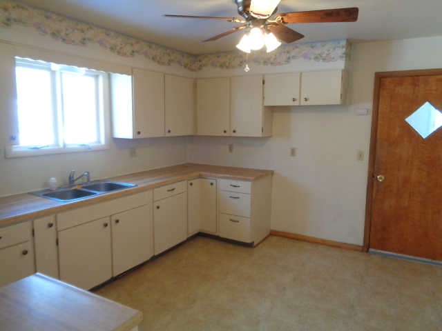 413 Phyllis Avenue Rochelle, IL 61068 - Photo 4 of 17 a kitchen with cabinets appliances a sink and a window