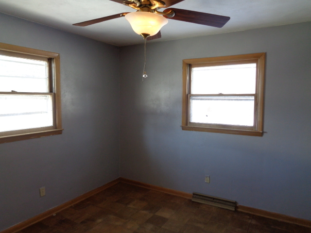 413 Phyllis Avenue Rochelle, IL 61068 - Photo 10 of 17 an empty room with a window and a fan