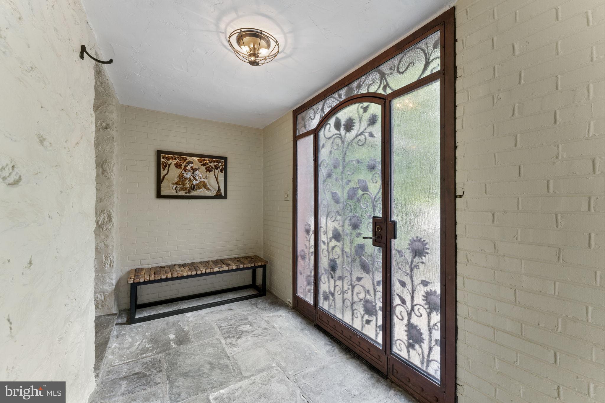 569 County Line Road Wayne, PA 19087 - Photo 6 of 64 Front Foyer with Slate Floor and Stone Wall