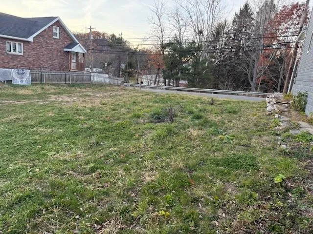 a view of a yard in front of house with an outdoor space