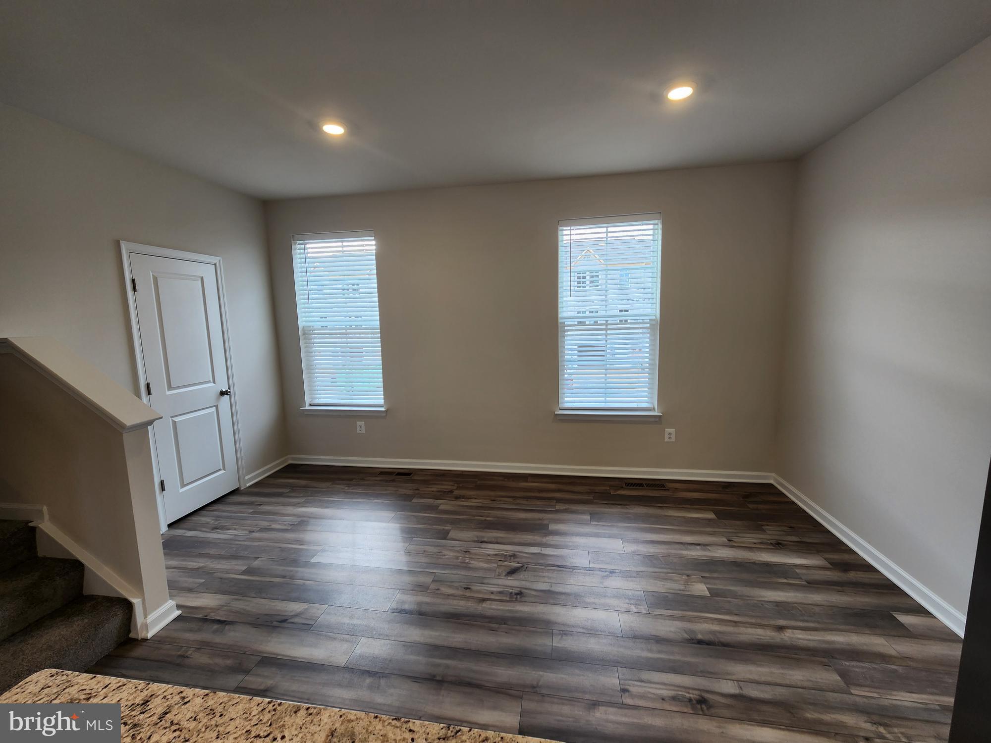 117 Canning Road Inwood, WV 25428 - Photo 18 of 41 an empty room with wooden floor and windows