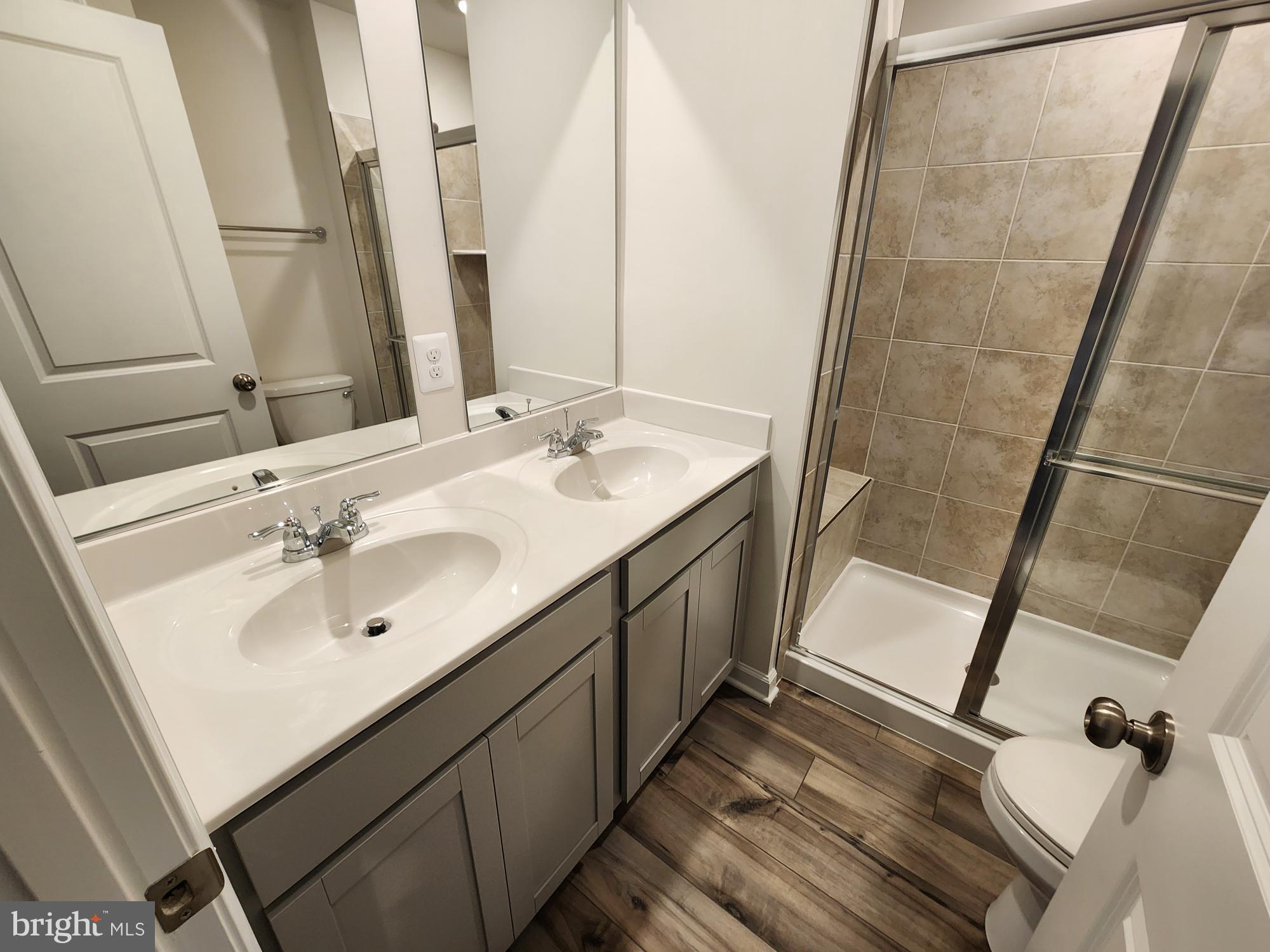 117 Canning Road Inwood, WV 25428 - Photo 23 of 41 a bathroom with a double vanity sink and a mirror