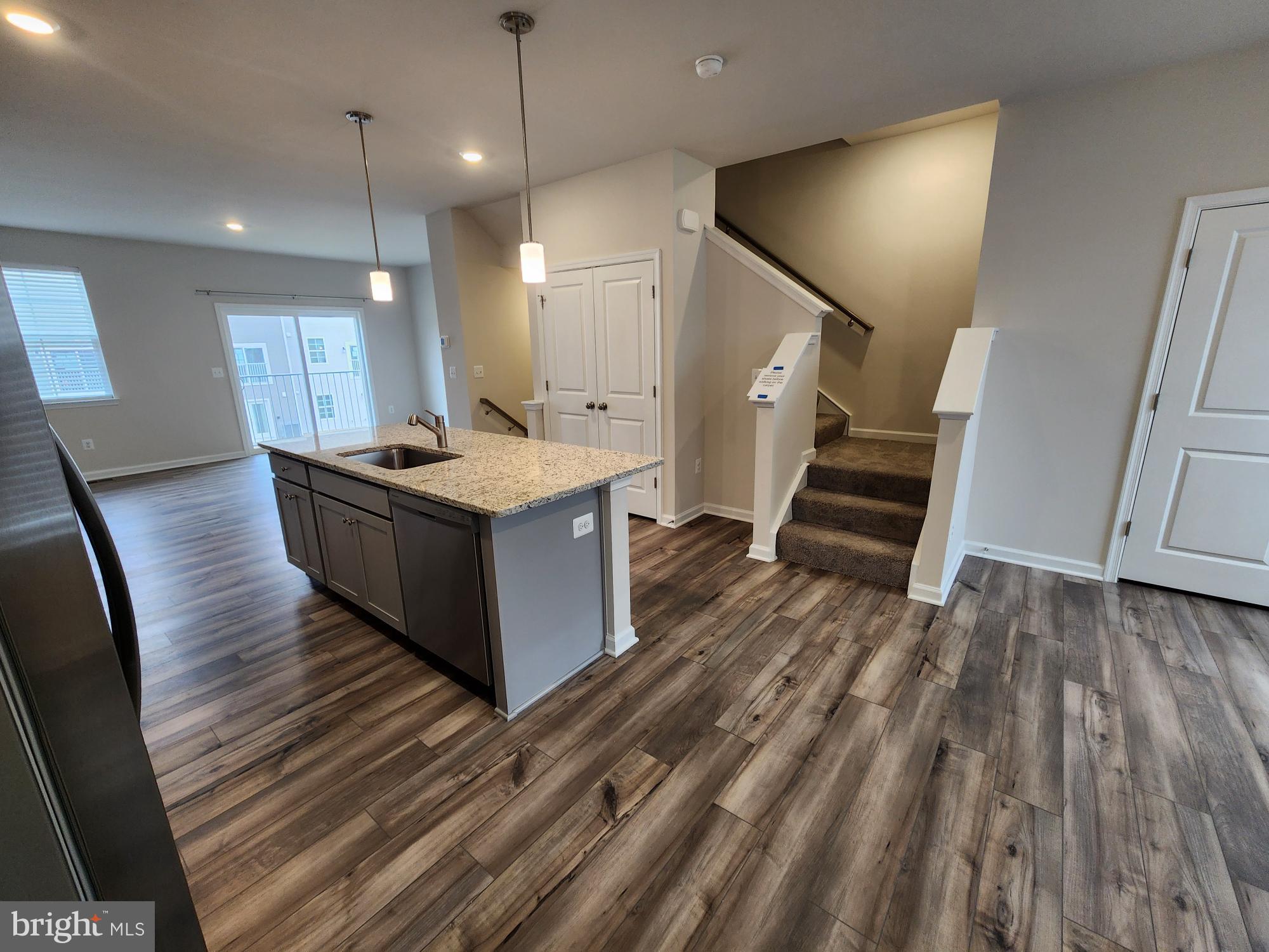 117 Canning Road Inwood, WV 25428 - Photo 5 of 41 a kitchen with kitchen island white cabinets appliances and wooden floor