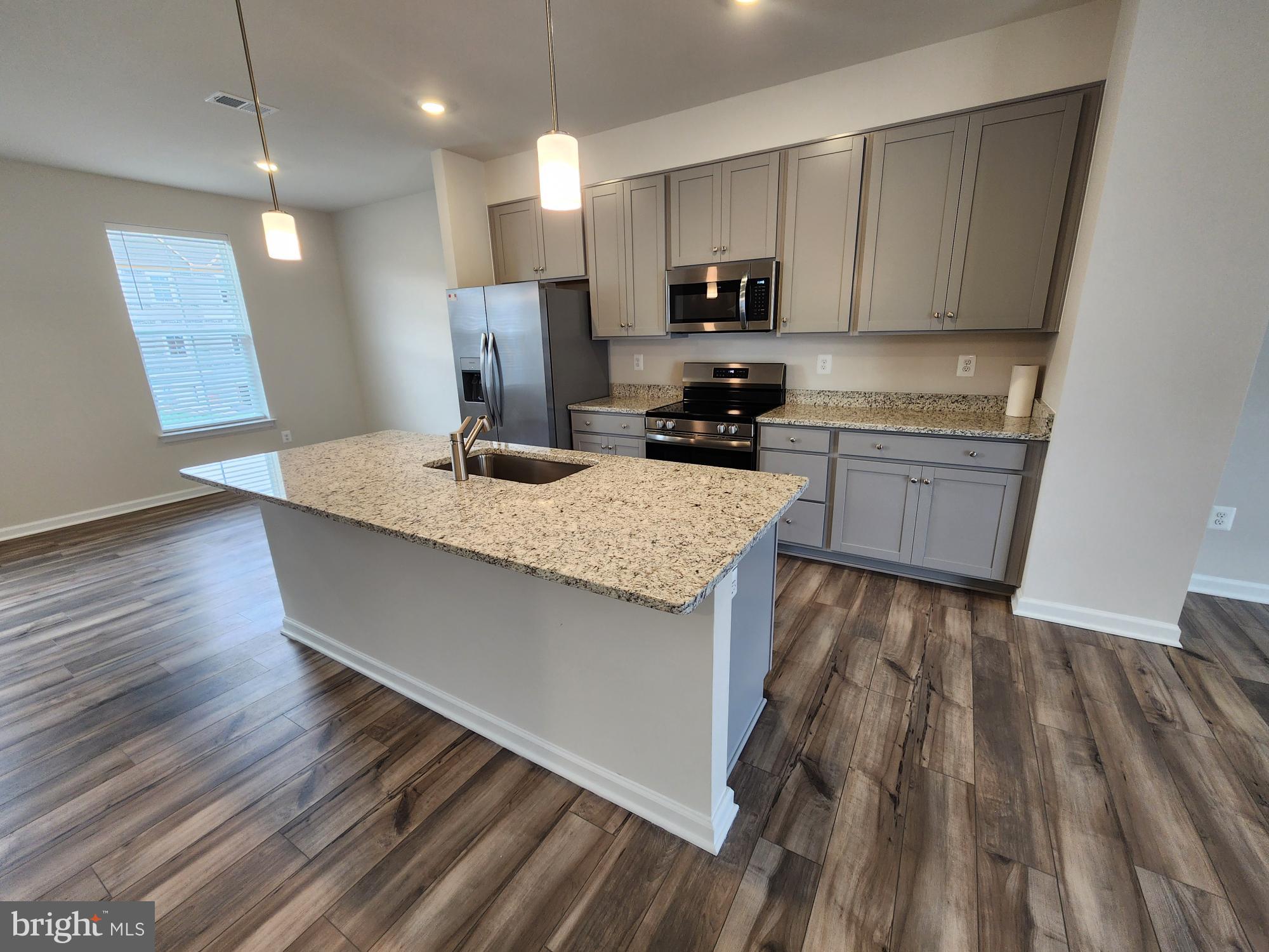 117 Canning Road Inwood, WV 25428 - Photo 7 of 41 a kitchen with a sink a microwave a stove and refrigerator