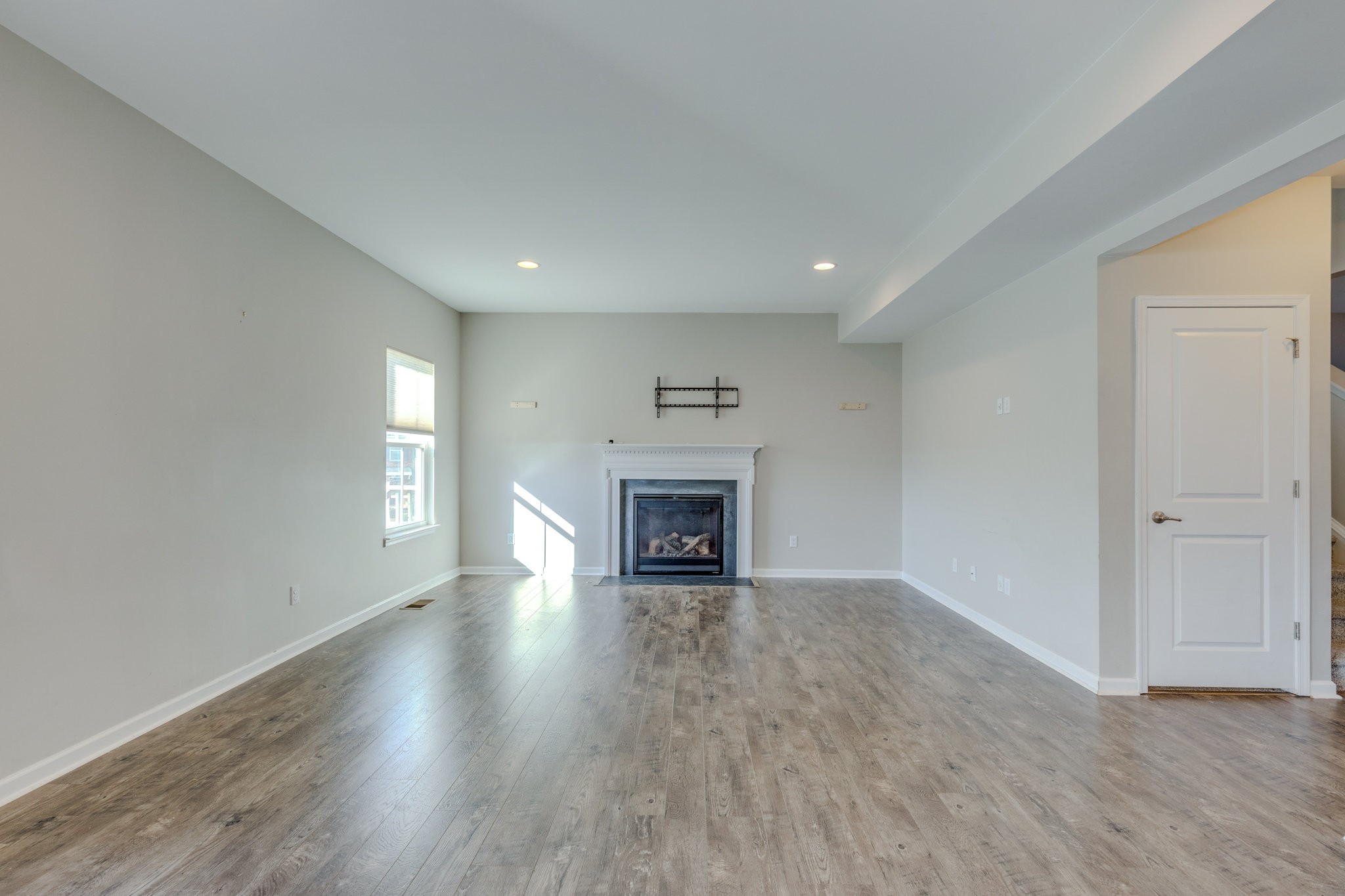 2704 Orleans Drive Columbia, TN 38401 - Photo 16 of 54 an empty room with wooden floor fireplace and windows