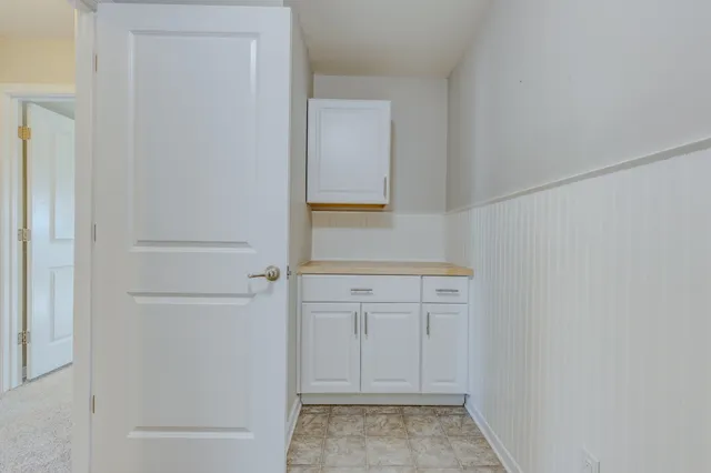 a view of a room with a ceiling fan and window