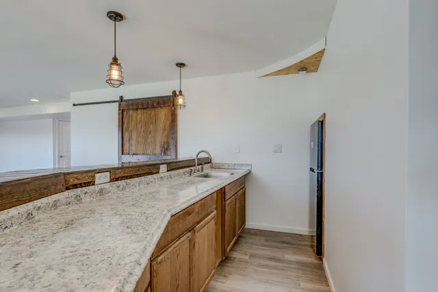 a bathroom with a granite countertop toilet and a sink