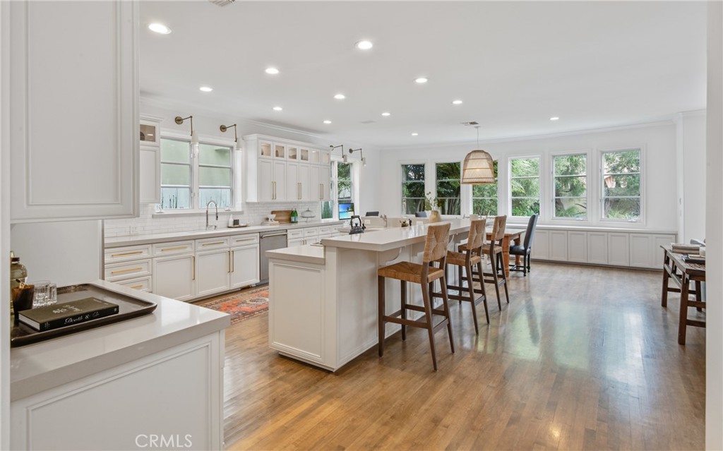 1427 Eighth Street Manhattan Beach, CA 90266 - Photo 20 of 47 a kitchen with stainless steel appliances a table chairs refrigerator and cabinets