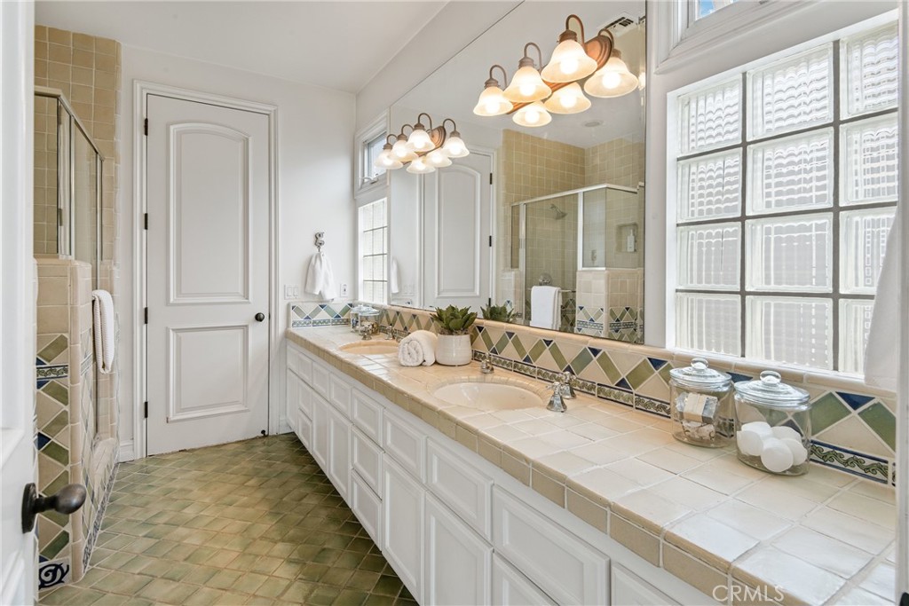 1427 Eighth Street Manhattan Beach, CA 90266 - Photo 40 of 47 a bathroom with a double vanity sink and a mirror