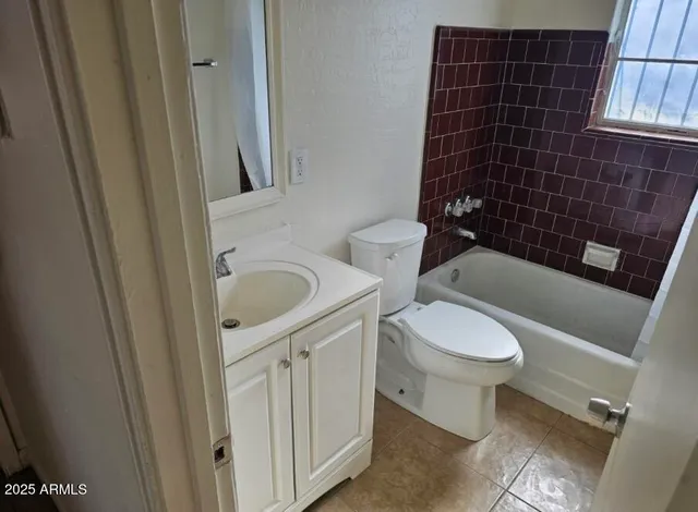 a white toilet sitting next to a bathroom sink and a shower