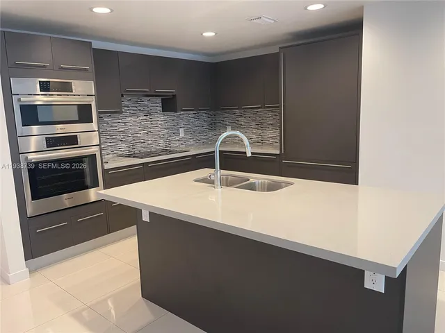a close view of a refrigerator a sink and wooden floor