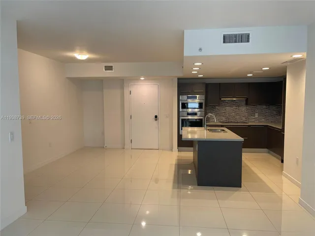 a view of kitchen with stainless steel appliances granite countertop cabinets