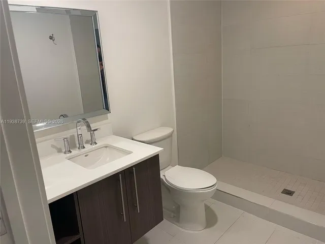 a kitchen with stainless steel appliances a sink a stove and microwave