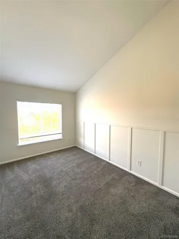 a view of an empty room and a window