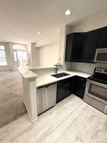 a kitchen with a sink stove and cabinets