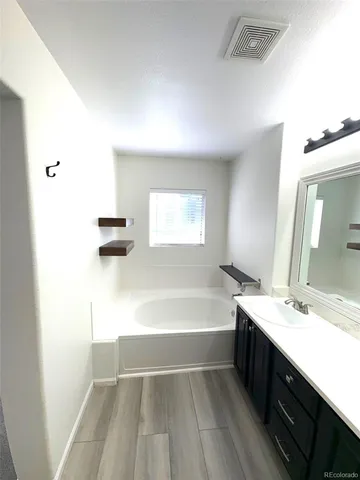 a bathroom with a sink mirror and shower
