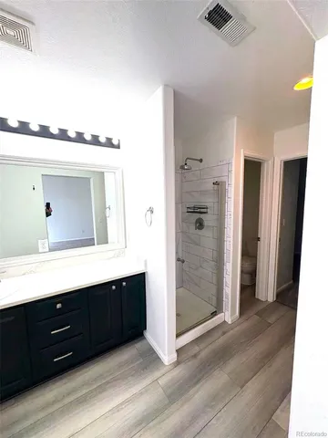 a bedroom with a bed and a large mirror