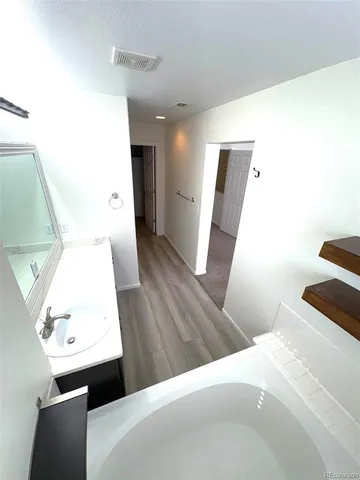 a white toilet sitting next to a white wall