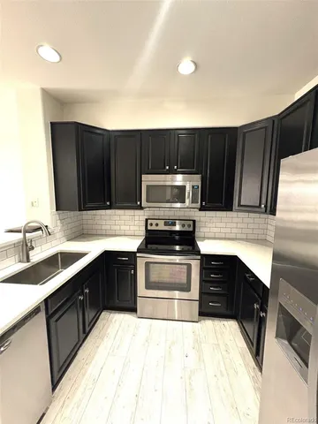 a kitchen with a sink stove and microwave