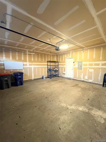 a living room with couches and a dining table with wooden floor