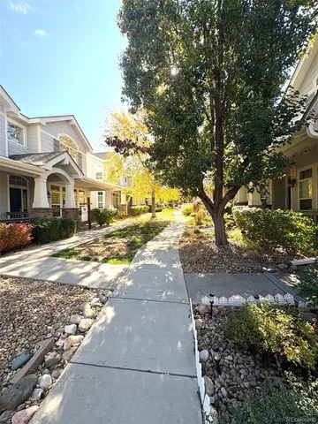 a view of yard with large tree and wooden fence