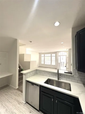 a kitchen with a sink and cabinets